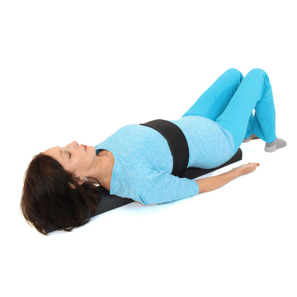 Person using a black foam roller to alleviate back pain